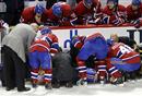 Training staff and memebers of the Montreal Canadiens tend to Max Pacioretty, who was run into a stanchion by Zdeno Chara of the Boston Bruins in the second period at the Bell Centre in Montreal, Quebec, on Tuesday, March 8, 2011.