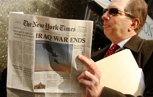 A man reads a spoof copy of the New York Times with the headline that the Iraq war has ended in New York, Wednesday, Nov. 12, 2008. About 1.2 million copies of a 14-page Times parody were handed out by 1,000 volunteers on behalf of prankster activists who say they want to make sure the newly elected Obama administration keeps its promises.