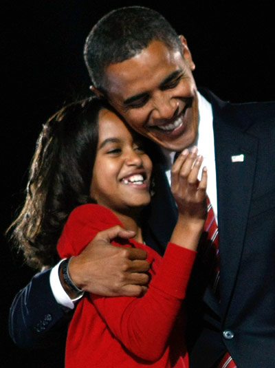 Barack Obama embraces his daughter Malia