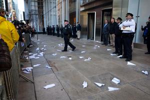 Paper airplanes made out of letters denouncing bank bailouts and issues related to the financial crisis lie on the ground after Occupy Wall Street protestors threw them towards the front of a Bank of America building, Friday, Oct. 28, 2011, in New York. Nearly 400 Occupy Wall Street protesters carried what they said were 7,000 letters of complaint to offices of banks they accuse of corporate greed. 