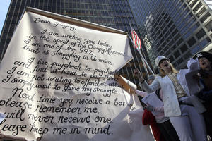 Occupy Wall Street demonstrator Monica Hunken sings a song in front of Wells Fargo's corporate headquarters during a march and rally in midtown Manhattan to deliver letters to bank CEOs at their corporate headquarters, Friday, Oct. 28, 2011, in New York.  