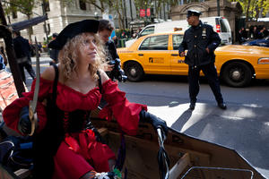 An Occupy Wall Street protestor dressed as a pirate rides her bicycle along 42nd Street during a march on banks in the midtown area, Friday, Oct. 28, 2011, in New York. Nearly 400 Occupy Wall Street protesters carried what they said were 7,000 letters of complaint to offices of banks they accuse of corporate greed. 