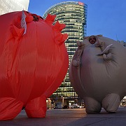 Two men in costumes advertise the film "The Yes Men Fix the World," playing at the Berlin International Film Festival.